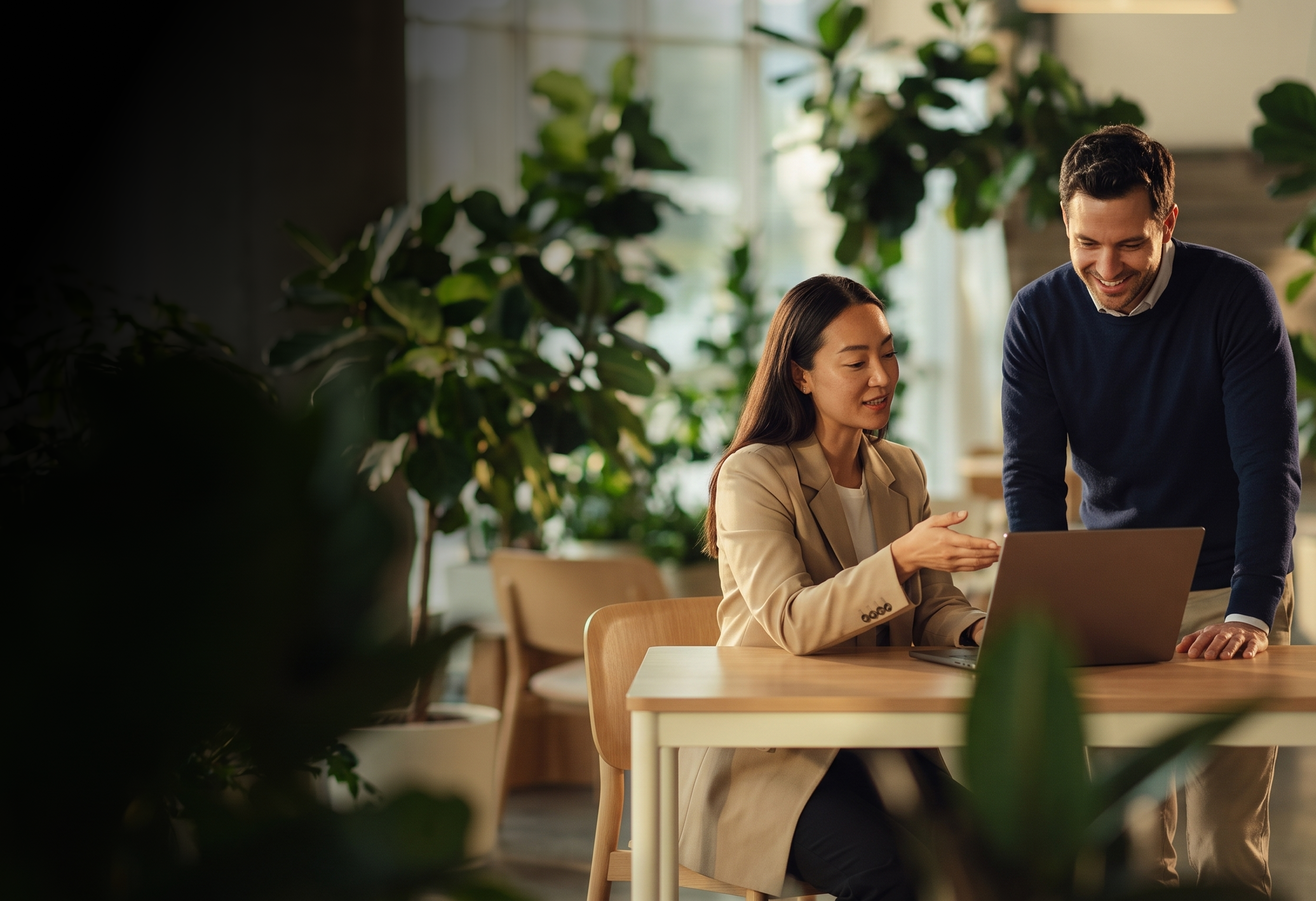 Two professionals reviewing business and technology strategy in a modern office